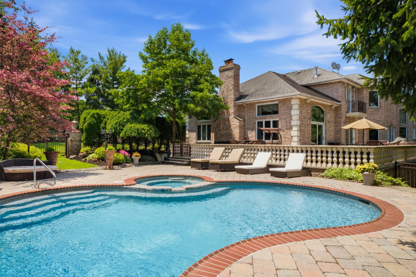 Resort-style rear grounds with terrace and pool